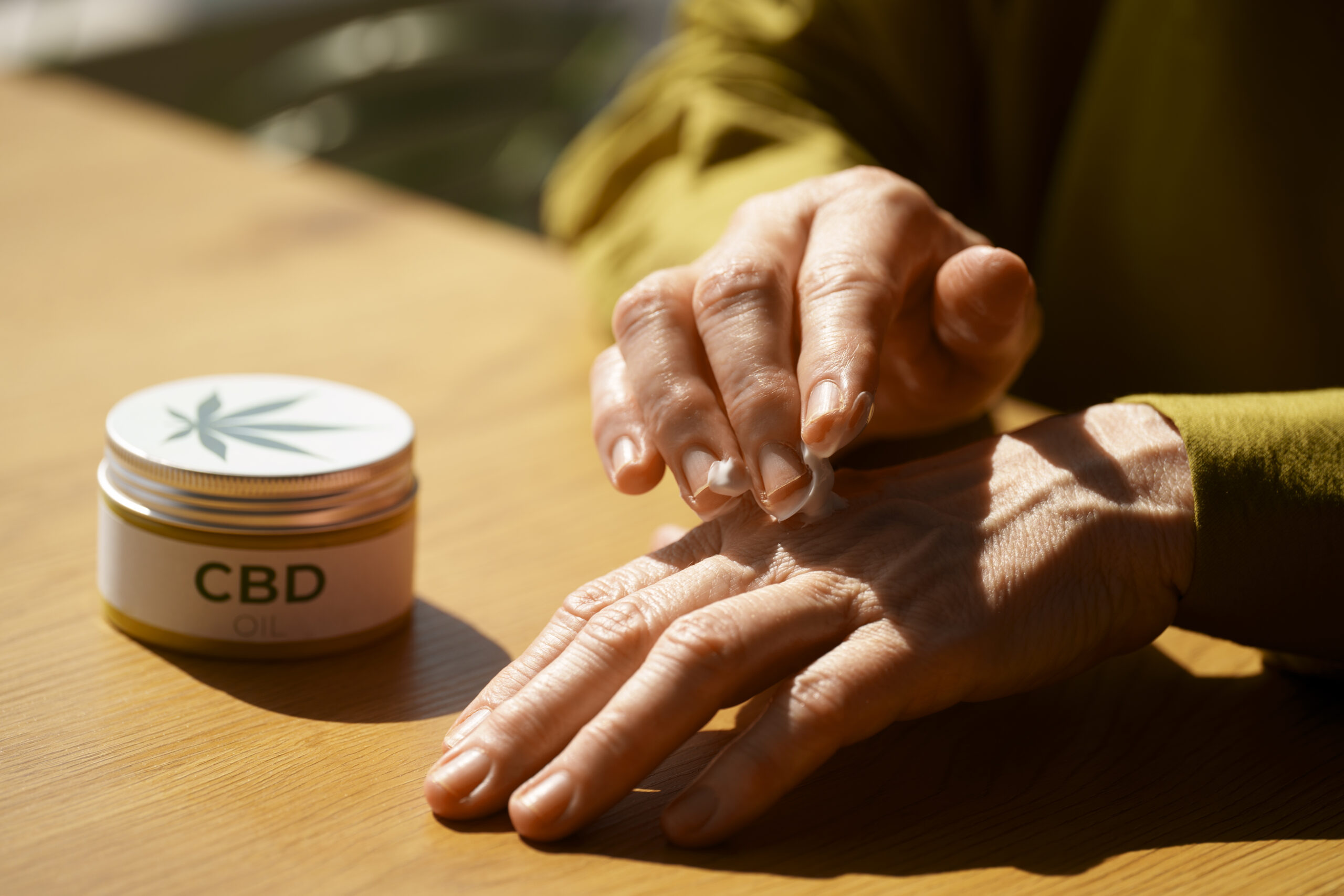 close-up-woman-using-cbd-cream-pain